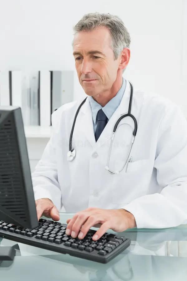 doctor-using-computer-medical-office-concentrated-male